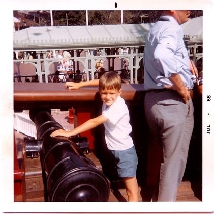 Ace as a boy at Disneyland in 1968, at a ship's cannon along the Pirates of the Caribbean queue.