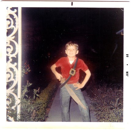 Ace as a boy, play-acting as a pirate in his backyard with the wooden sword his great uncle carved.